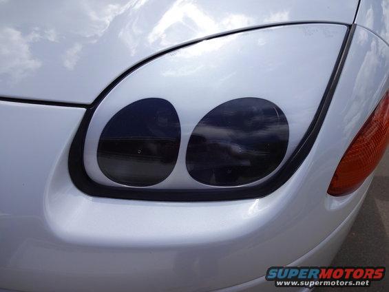 1995 Mitsubishi 3000GT front headlight assembly with dual blacked-out projectors
