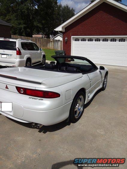 1995 Mitsubishi 3000GT convertible parked in driveway next to an SUV