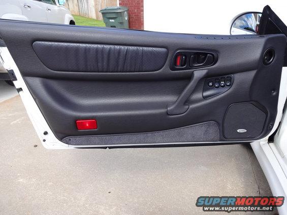1995 Mitsubishi 3000GT interior door panel with power window controls and speaker
