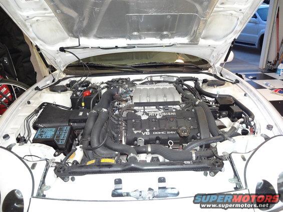 White 1995 Mitsubishi 3000GT engine bay with hood open, showing V6 DOHC 24V engine
