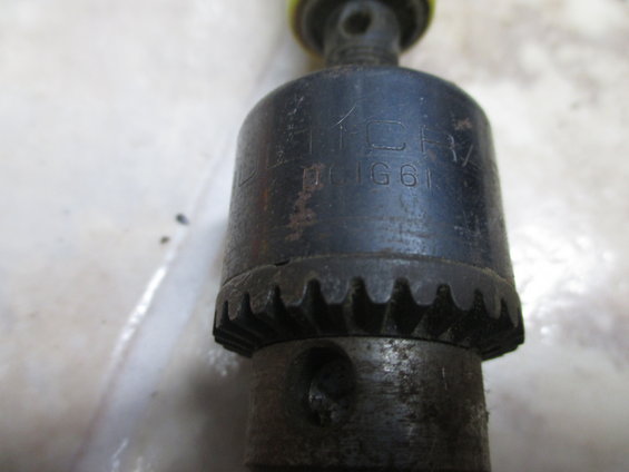 Close-up of a drill chuck with markings 'D10JG61'