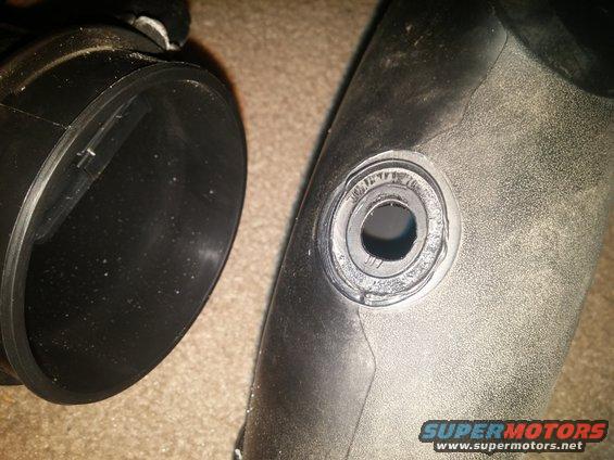 Black air intake hose with a circular opening
