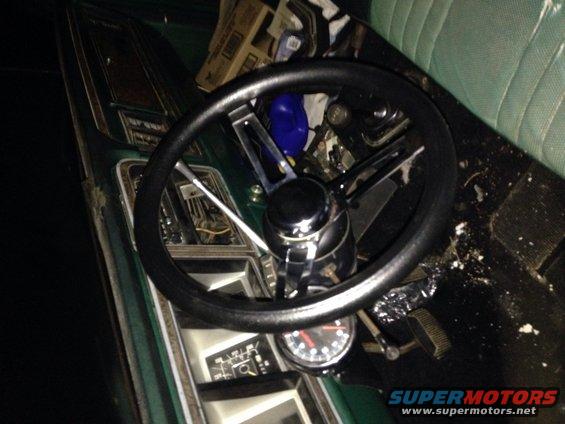 Green interior of a 1978 Ford Bronco with a black steering wheel and dashboard gauges