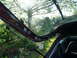 1993 Mazda MX-3 - View from inside a car's open trunk, looking out at a sunny garden scene.