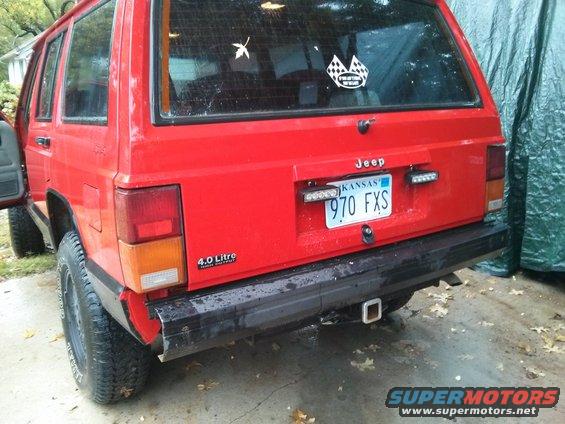 Red Jeep Cherokee XJ rear view, Kansas license plate 970 FXS, 4.0 Litre badge