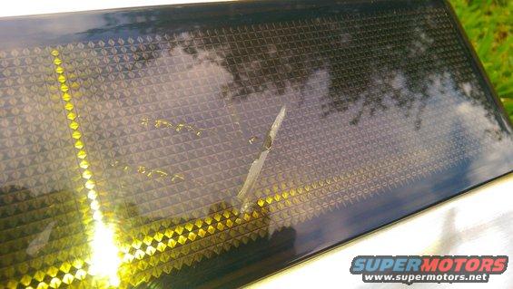Rear tailgate applique with diamond pattern and yellow lights