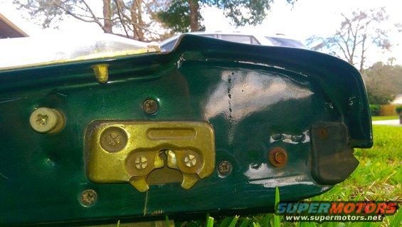 Green tailgate latch mechanism with gold-colored hardware