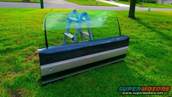 Car door with two-tone paint and a ladder behind it on grass
