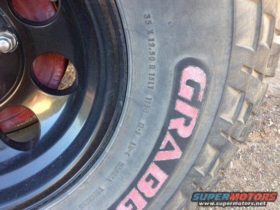 Close-up of a tire with 'GRAVEL' written on it and a black wheel