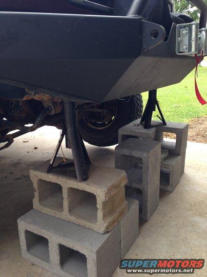 Rear bumper supported by jack stands and cinder blocks