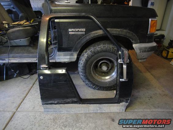 Black Ford Bronco fender and door frame with a tire visible