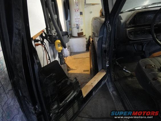 1988 Ford Bronco interior with door panel removed and torn seat visible