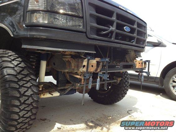 Front grille and bumper of a black 1996 Ford Bronco with large tires