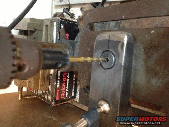 Drill bit entering metal part with visible text 'SEARS CRAFTSMAN Quick-grip'