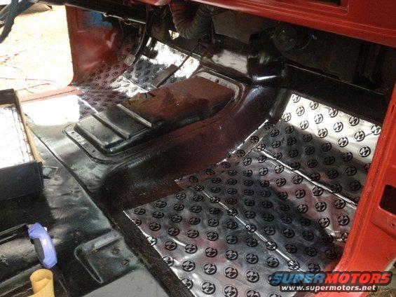 Truck interior floor with sound deadening material. Shows transmission tunnel and pedals