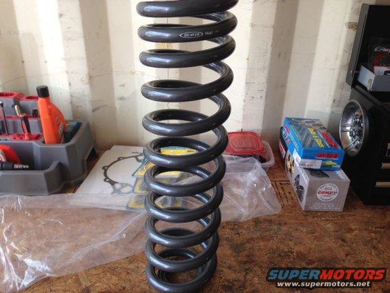 Coil spring with 'BEAVER' text, next to tools and boxes