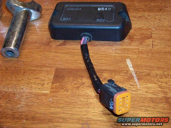 Black electronic control module with wiring harness and connector, part number 32466-95 A, 9549, 883-R, REV-. Connector is orange with 9 pins