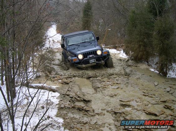 dscn0161.jpg My buddy in his TJ.  He'd rather be climbing rocks, but we managed to get him dirty today.