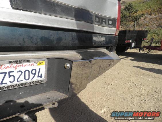 Silver Ford truck rear bumper with California license plate Z52094, towing a flatbed trailer