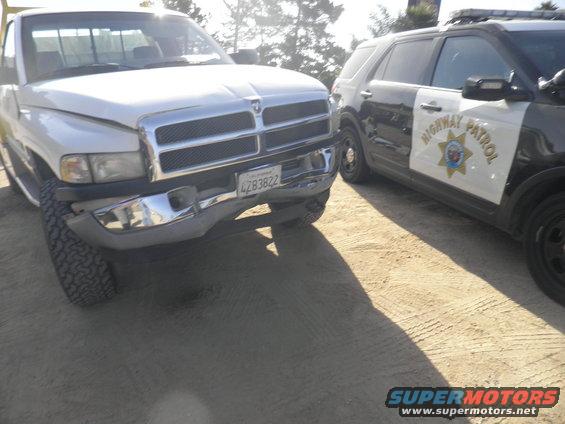 White Dodge Ram pickup truck parked next to a highway patrol SUV. License plate 4Z83822