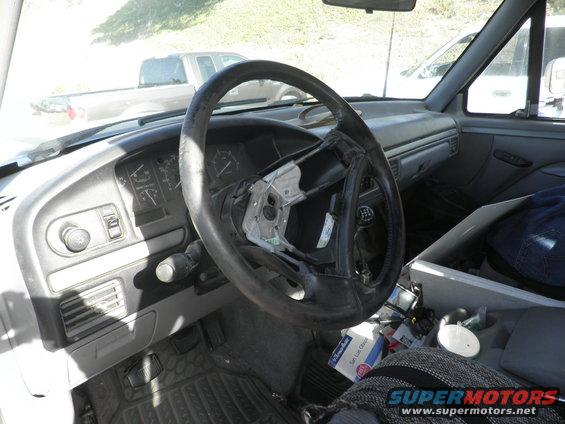 1994 Ford F-250 interior with damaged steering wheel and dashboard