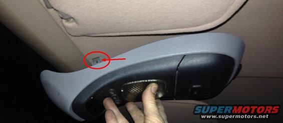 overhead console light fixture with a red circle pointing to a clip