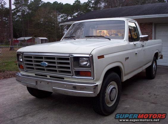 White 1980s Ford F-250 pickup truck, front 3/4 view