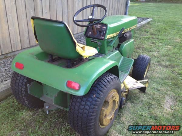 Green John Deere lawn tractor with yellow seat, viewed from the rear