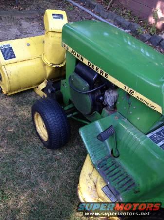 Green John Deere tractor with yellow snow blower attachment, model 112 Electric Lift