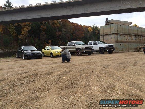 2006 Chevrolet Silverado 2500 parked with other vehicles under a bridge