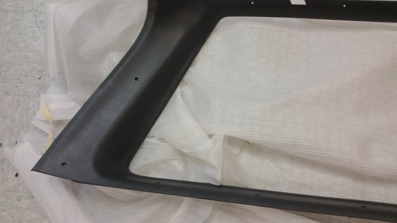 Black plastic trim piece, likely for a vehicle window frame