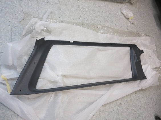 Black plastic trim piece for a car's interior, possibly a pillar cover