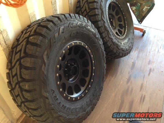 Two off-road tires mounted on black Method wheels