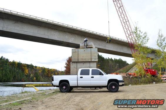 White 2006 Chevrolet Silverado 2500 parked by a bridge under construction