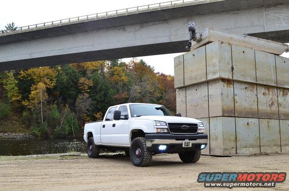 White 2006 Chevrolet Silverado 2500 pickup truck parked under a bridge