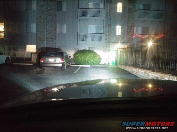 Rear of a silver 2000 Mercury Grand Marquis parked in a lot at night