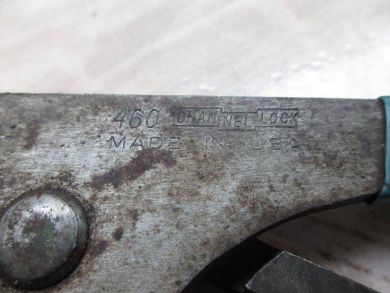Close-up of worn metal Channel Lock pliers with model number 460 and "MADE IN USA" stamped on the side