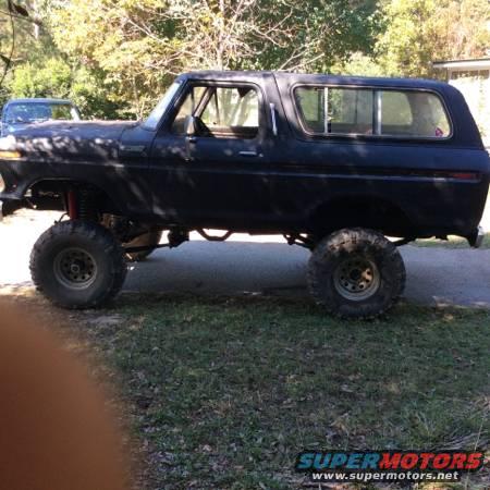 Lifted 1978 Ford Bronco, side view. Large off-road tires and suspension visible