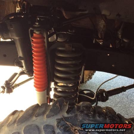 Front suspension coil spring and red shock absorber with white body