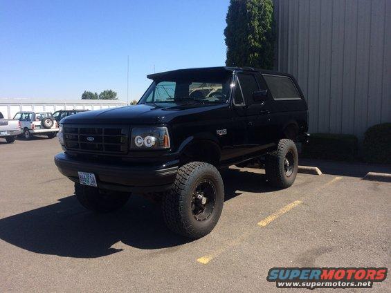 Black Ford Bronco parked in a lot. License plate reads 666 FSA