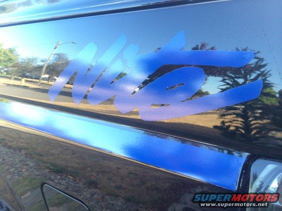 Blue Nite decal on side of dark vehicle