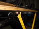 1992 Ford Bronco - Vehicle chassis components are visible, supported by yellow stands.