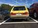 1983 Volkswagen Rabbit - Rear view of a 1983 Volkswagen Rabbit parked in a lot next to other vehicles.