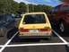1983 Volkswagen Rabbit - Rear view of a yellow hatchback with a license plate from Alabama.