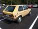 1983 Volkswagen Rabbit - A tan 1983 Volkswagen Rabbit is parked in a lot, showing its rear and side profile.
