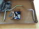1997 Dodge 3500 - A sway bar kit, including a metal bar and blue bushings, is laid out in a cardboard box.