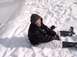 1990 Ford Bronco - A person is sitting in a snowy landscape, wearing winter clothing.