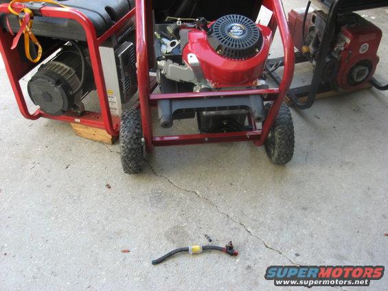 Two portable generators on a concrete surface, one red with a black engine, the other red and black