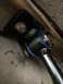 1997 Dodge 3500 - Close-up view of a sway bar assembly blue polyurethane bushings and a black mounting bracket.