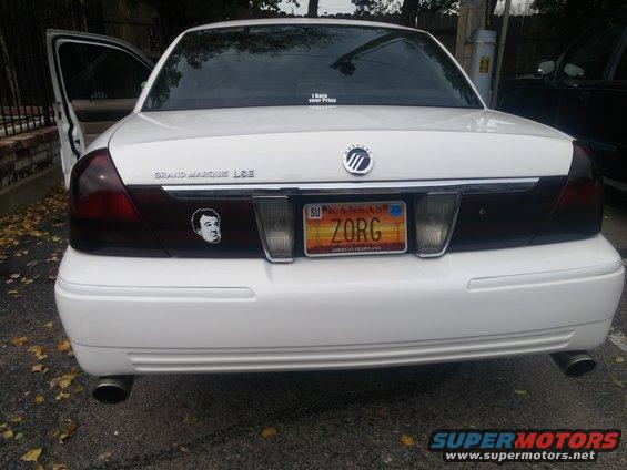Rear view of a white 2000 Mercury Grand Marquis LSE with a Kansas license plate reading ZORG